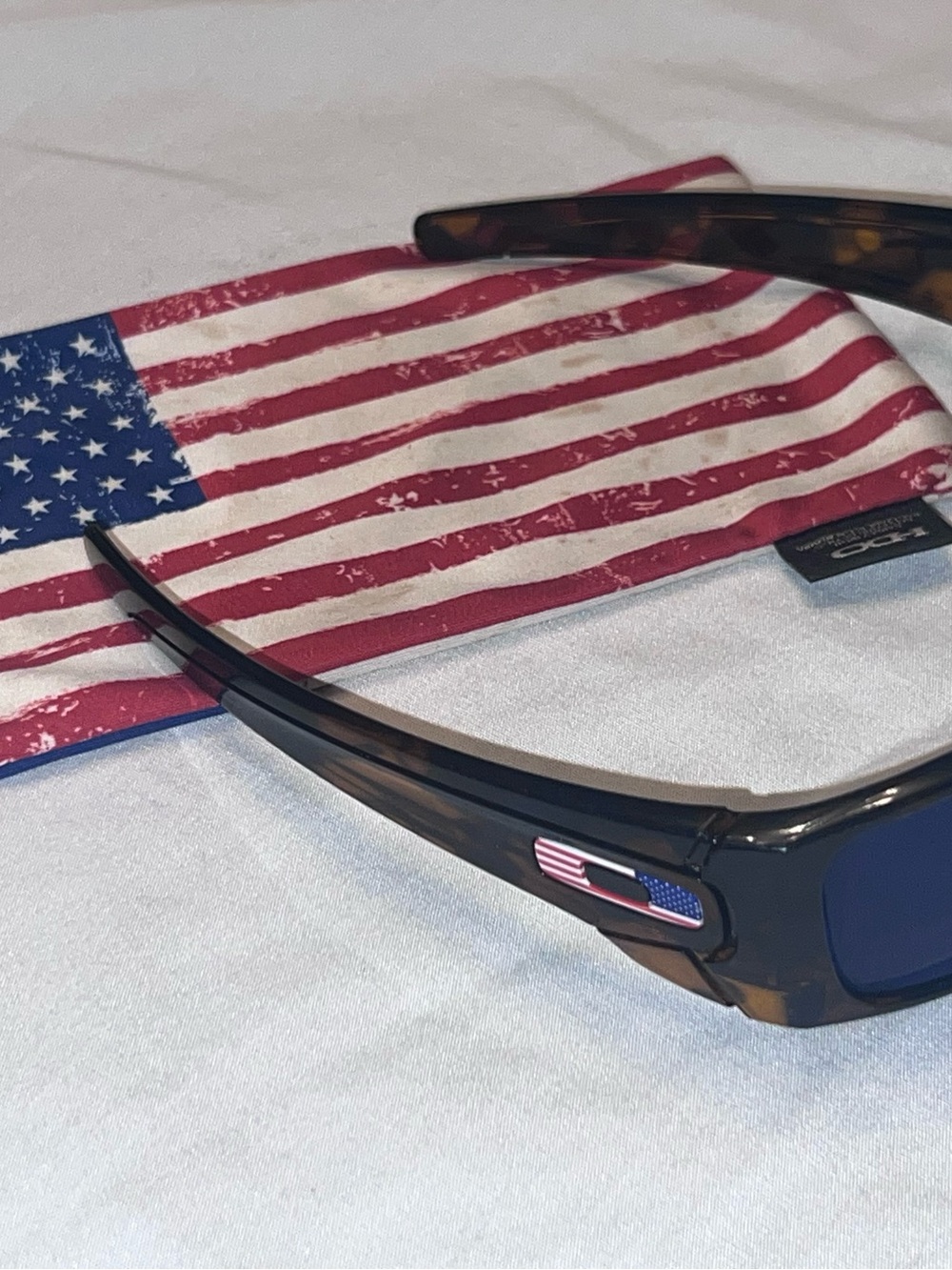 Oakley Tortoise Frame Sunglasses with Blue Lenses and American Flag Accent